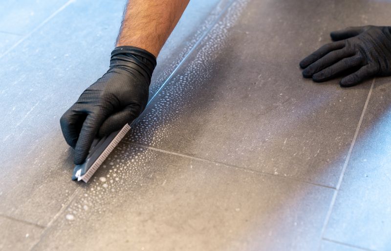 A professional preparing grout